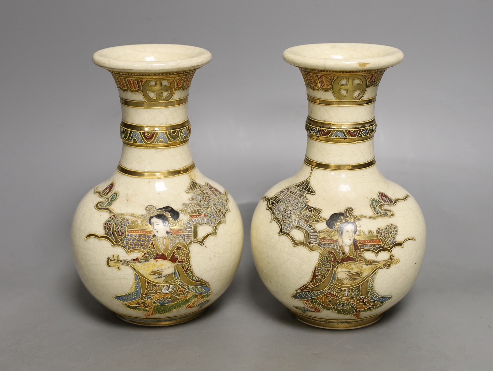 A pair of Japanese Satsuma vases, signed, 17 cms high.